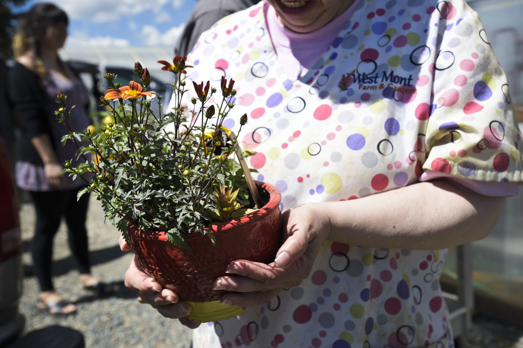 Vikki Thomson shows off one of the potted plants Tuesday.